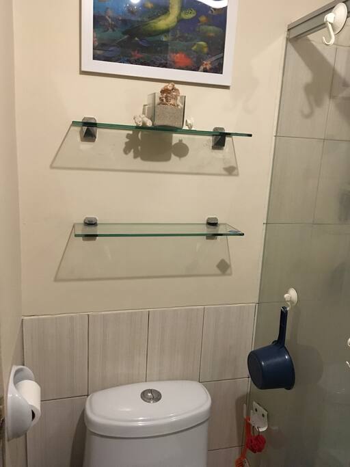 Toilet seat separated from the shower room with glass sliding door