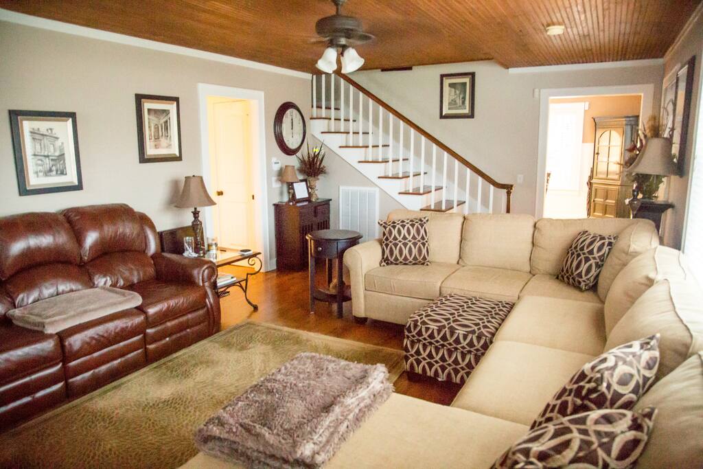 Spacious living room with lots of comfortable seating around the fireplace.