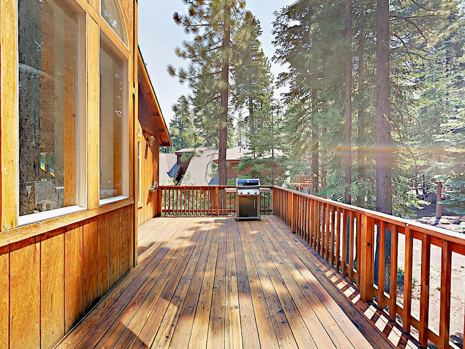 The roomy deck overlooks the wooded property.