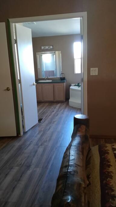 Master bathroom from bedroom. Garden tub, shower and separate room for toilet.