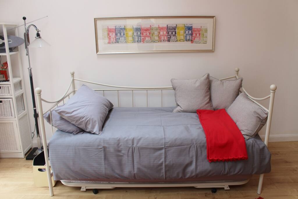 A daybed gives flexible accommodation. Here it is made up for one person as a single bed (90cm x 190cm). A trundle with another single bed hides underneath.