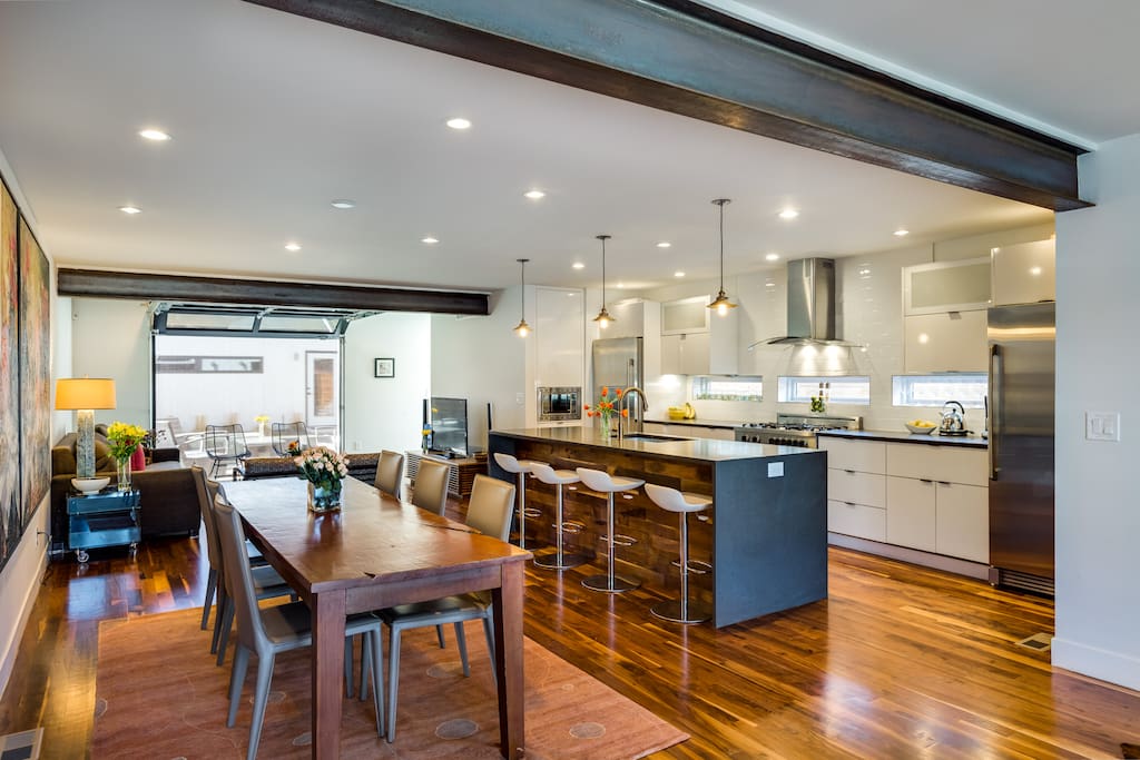 Bright, open living room, dining room, kitchen and garage style door to private backyard