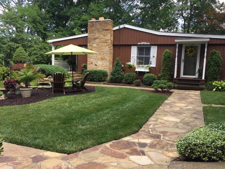 Sideyard showing chairs by pond