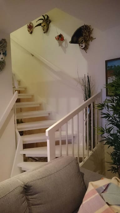 Stairs to the first floor with two bedrooms and bathroom