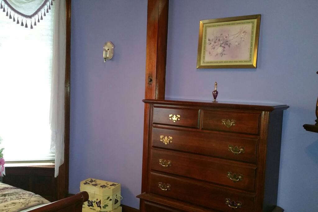 Tall dresser to the right of the bedroom.