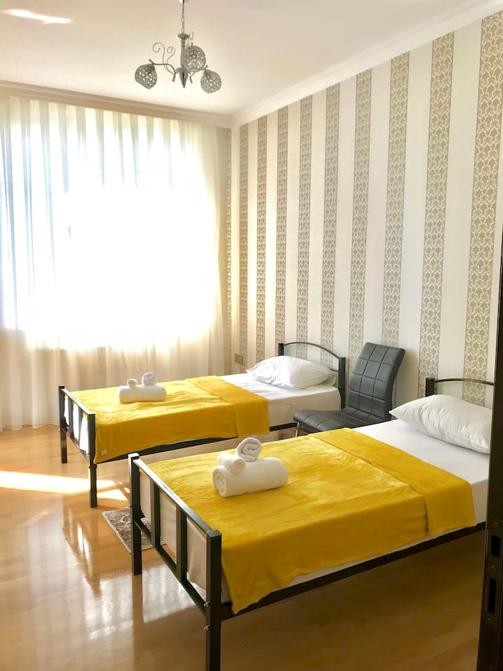 Second bedroom with two single beds setup for business travelers 