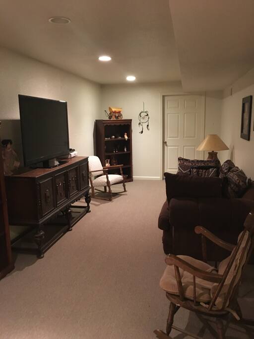 Basement living room with cable, Xbox 360, large loveseat.