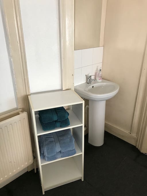 The room has a sink and towels provided.