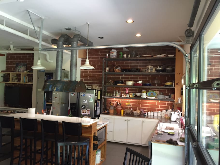 Open kitchen. The hood is a half barrel :) Steel shelves, stainless steel counter.
