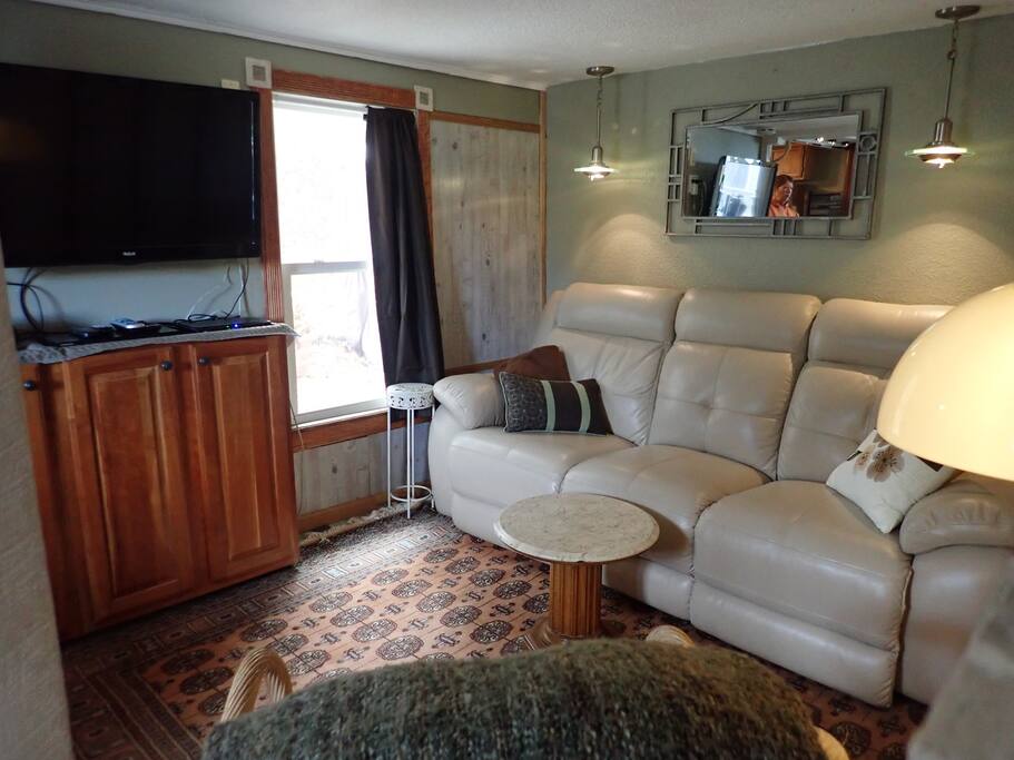 TV swivels on a wall mount to watch from couch
