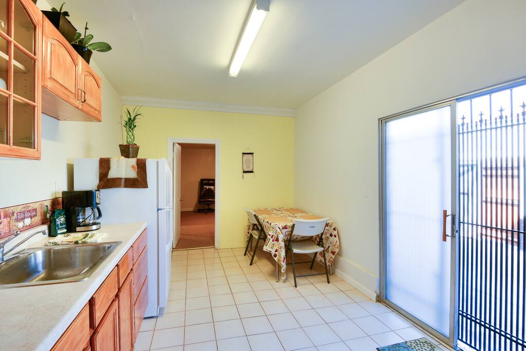 Clean Kitchen with toaster , microwave, and hot pot.