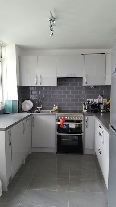 Open plan Kitchen with all key appliances including cooker, washing machine, dishwasher. fridge/freezer