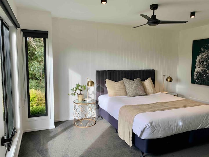 King size bed overlooking the private north facing native garden. 