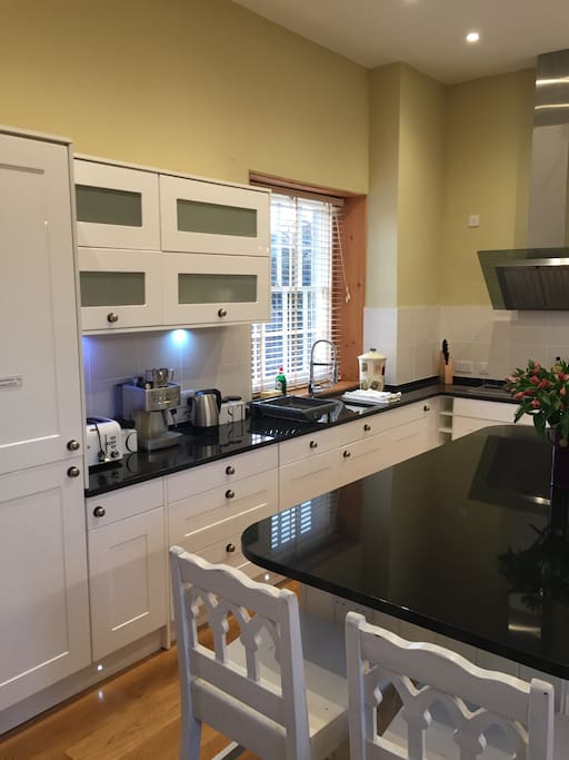 Well equipped kitchen with granite work surfaces.