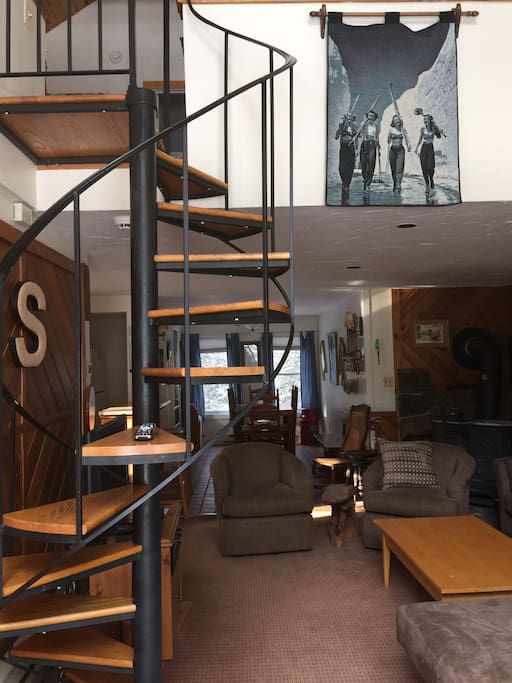 spiral staircase up to queen bed in loft, bedroom, bath and single