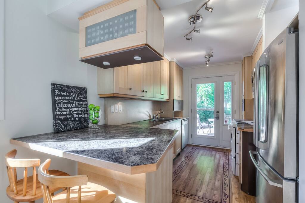 Large fully equipped kitchen with walk-out to large deck overlooking magnificent backyard.