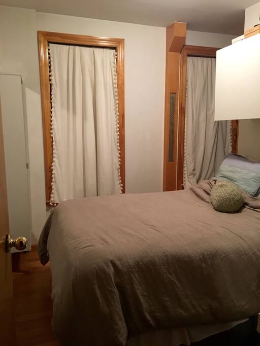 Queen sized bed and blackout curtains on the windows to ensure a peaceful night's sleep