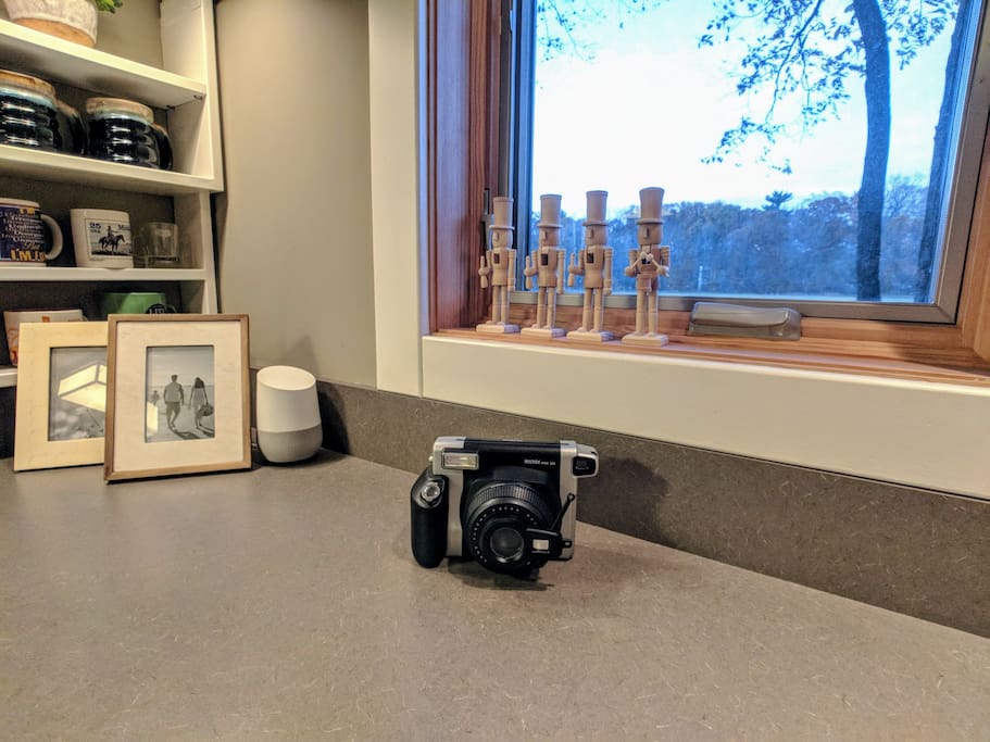 Capture the moment (and take it with you) with the Instax camera. Google Home speaker is photo-bombing in the corner.