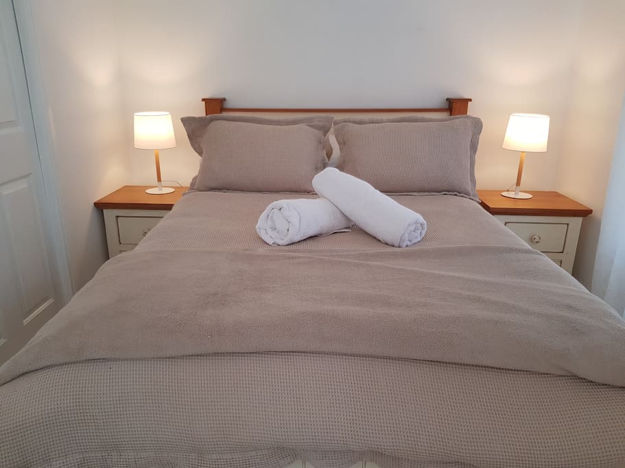 Double bed freshly made with quality linen,