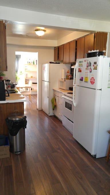 Kitchen with appliances, dishes and cutlery