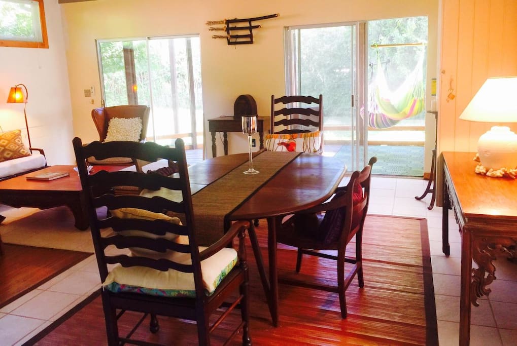 Bright sunny living/dining room looking out to enclosed porch