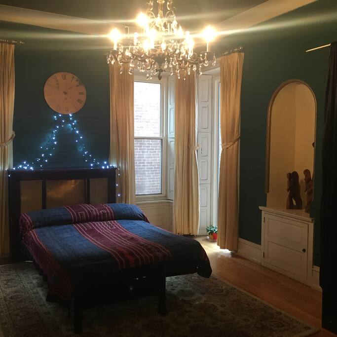 This huge room has a sculpture niche, and a full windows looking into the glass filled studio and into the playground across the street