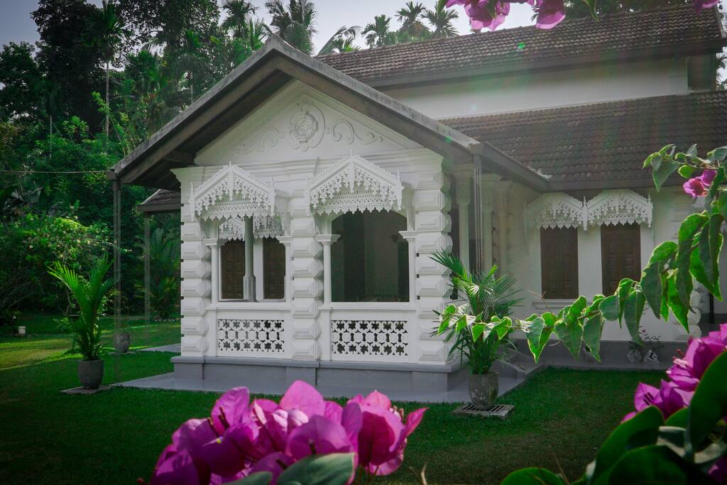 The view of the house on entering the tall wooden gates.