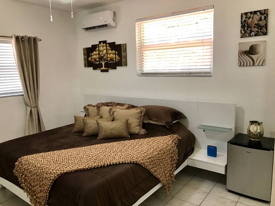 View of the king size bed along with a compact refrigerator for your convenience!