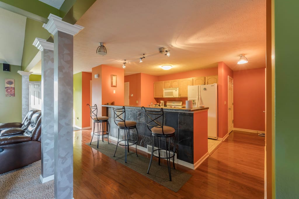 Family Room. The living room, dining room, and kitchen are combined creating a perfect place for entertaining family and friends. Beautiful hardwood floors run from the front door into the dining area. The kitchen has a three seat bar.