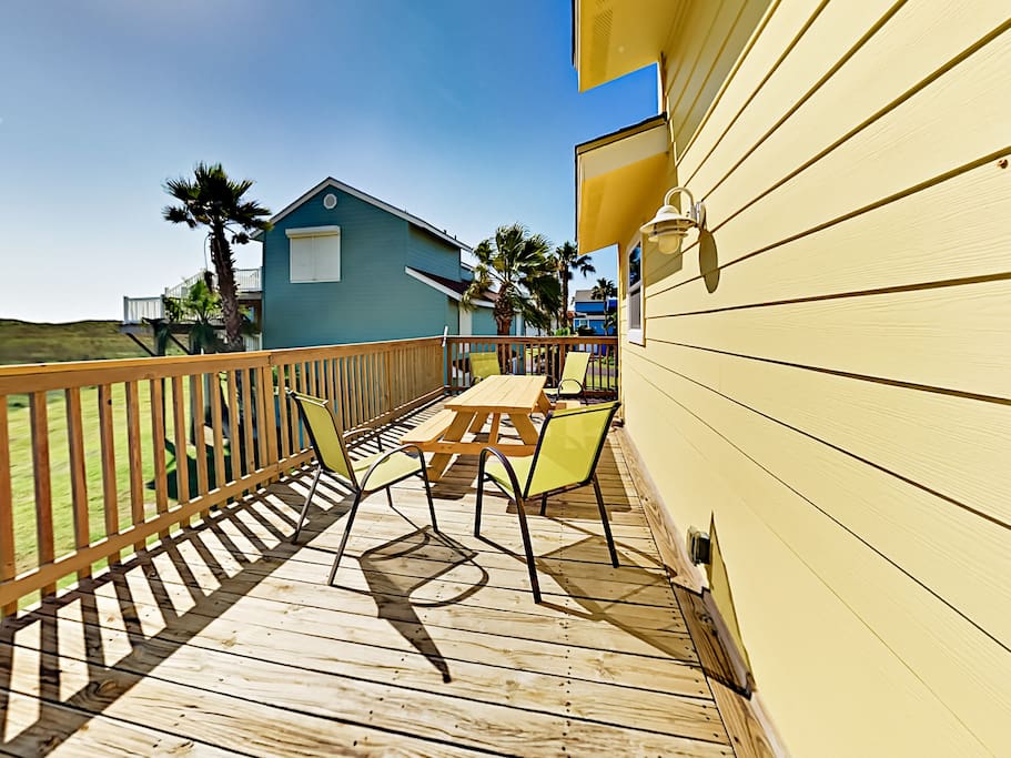 Breezy 2nd-floor balcony with picnic table and ample seating.