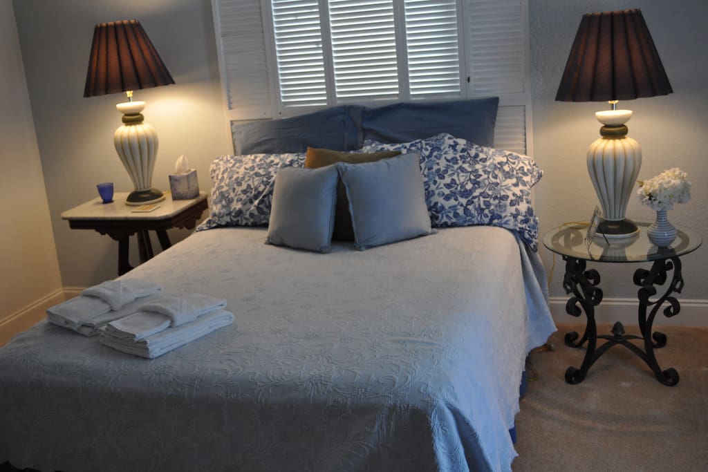 Very comfortable queen sized bed with side tables and a dresser for storage.