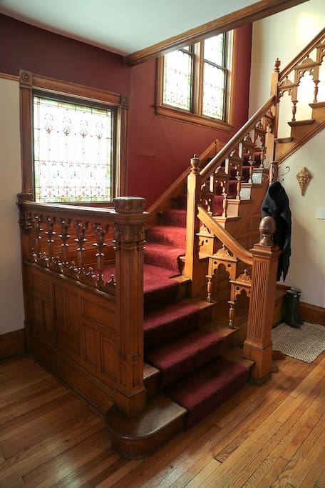 Beautiful main staircase, hand carved railings and stained glass.