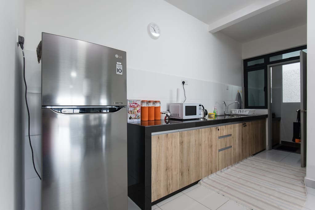 Kitchen with fridge, electric kettle, microwave oven & gas cooker