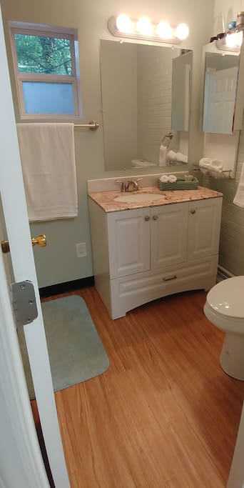 A clean bathroom offering a walk-in shower and over-sized bath sheets