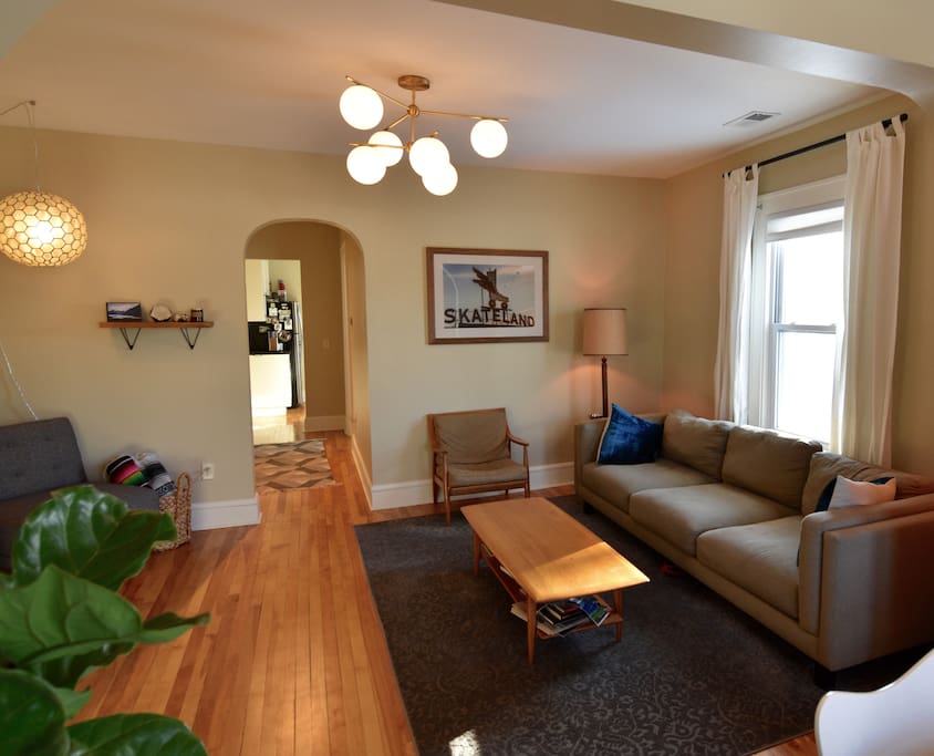 Living room with extra long comfy couch and TV with Netflix, Amazon Prime, and Hulu.