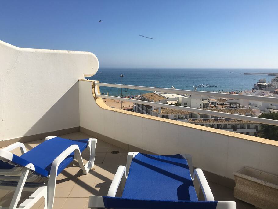 View from top balcony with loungers and hammock also awning.