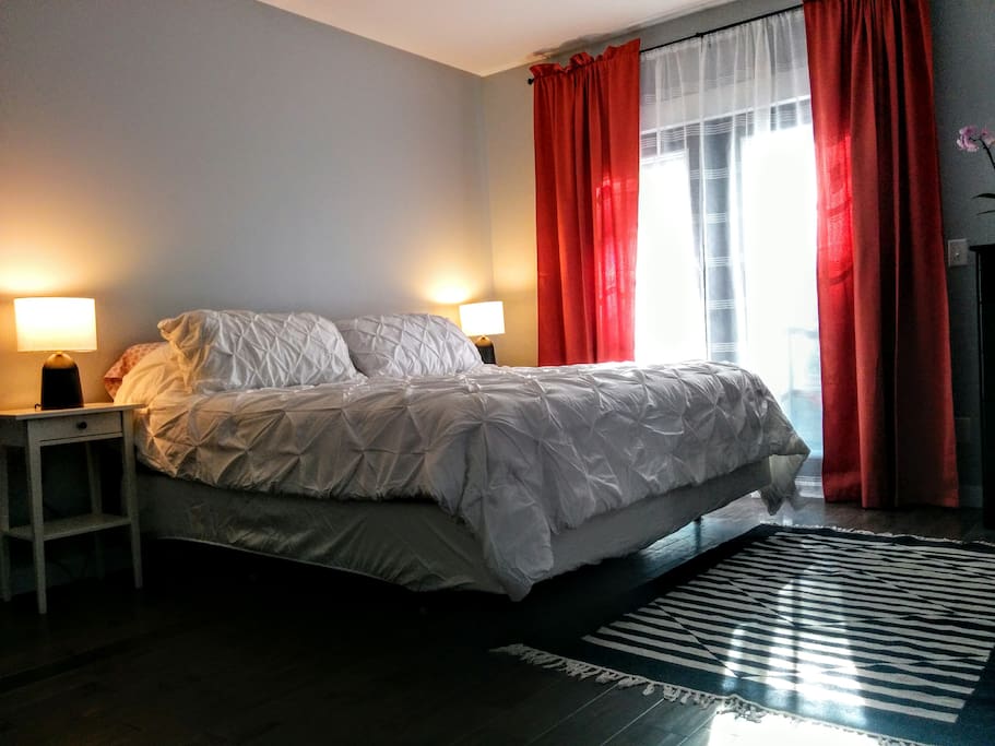Another view of the king bed in the first bedroom close to evening.