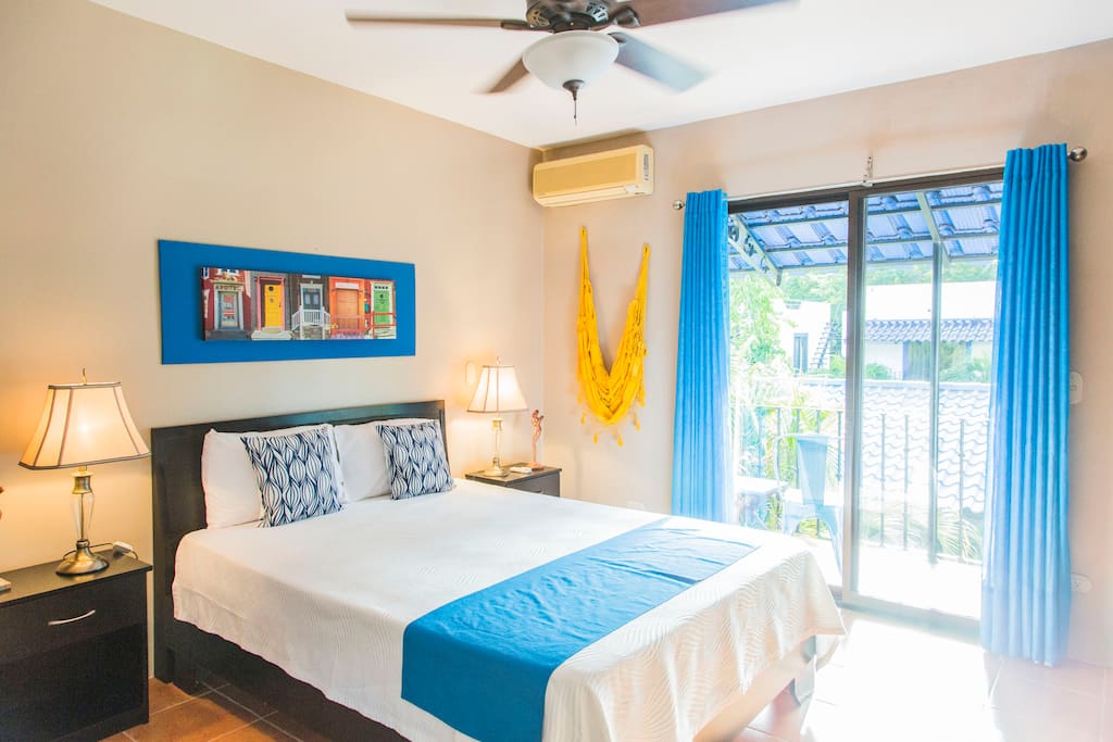 Master bedroom with private balcony facing pool