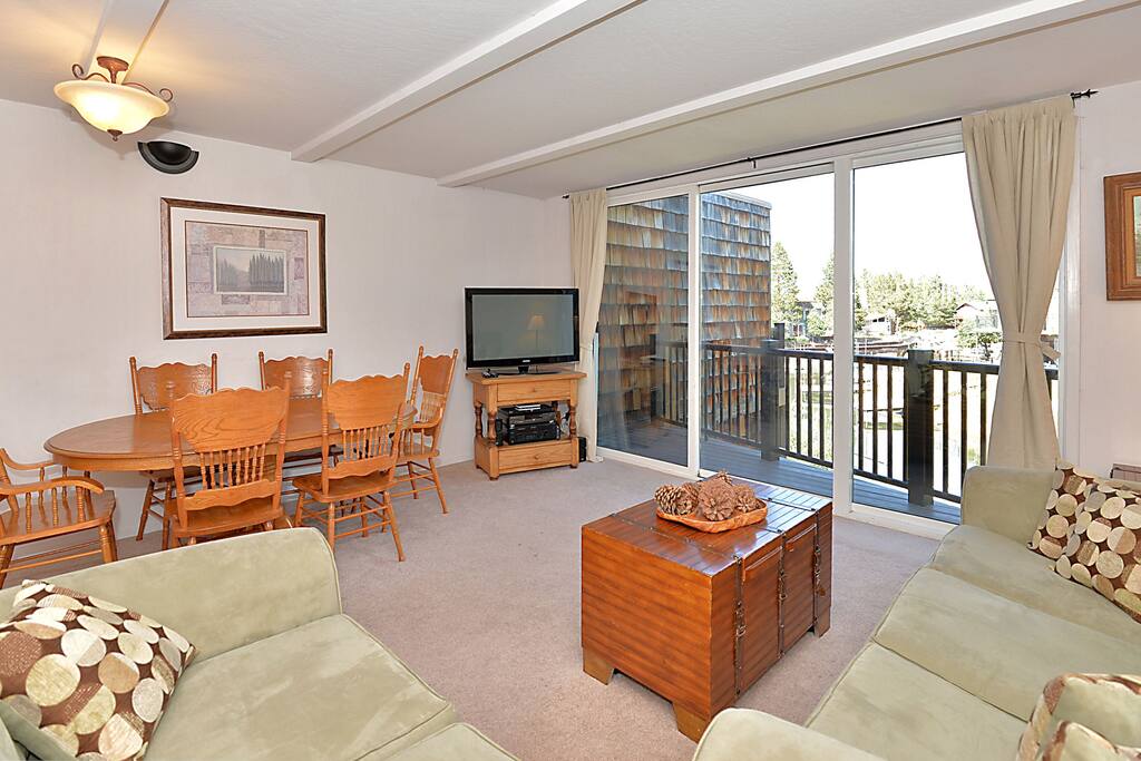 Floor-to-ceiling sliding glass leads to the water-view balcony.