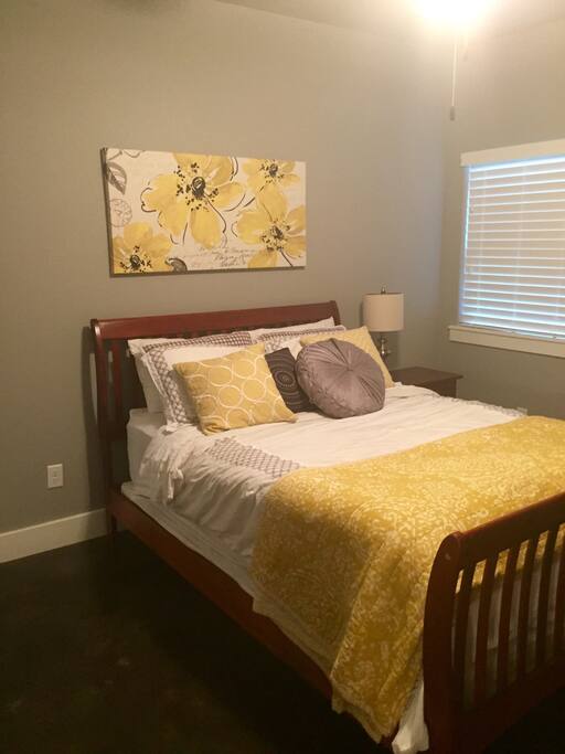 Queen size bed with a dresser and closet.