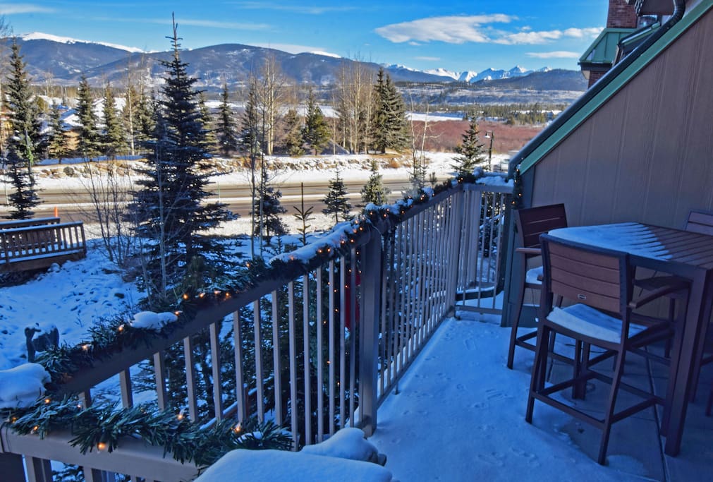 The balcony deck with snow on it.