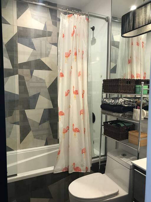 clean bathroom stocked with toilet paper and fresh towels