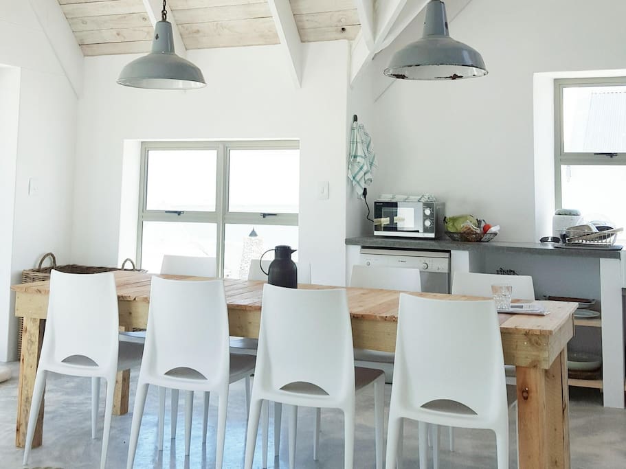 The dining area. Kitchen on the right, outdoor porch and braai (BBQ) area (panoramic views) to the left
