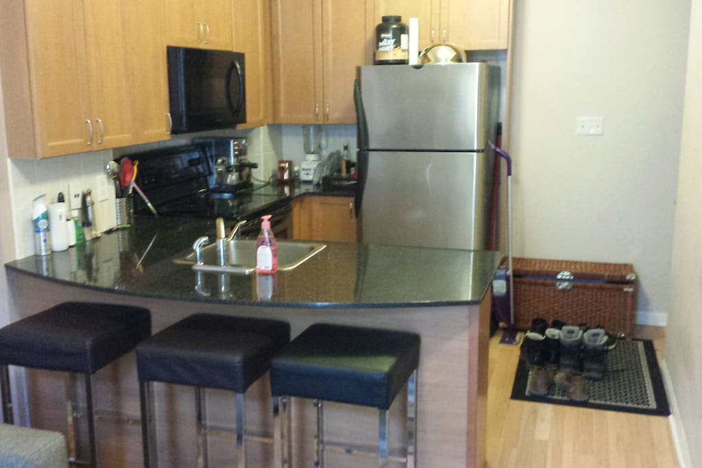 Kitchen includes dishwasher, Flattop stove, microwave, blender