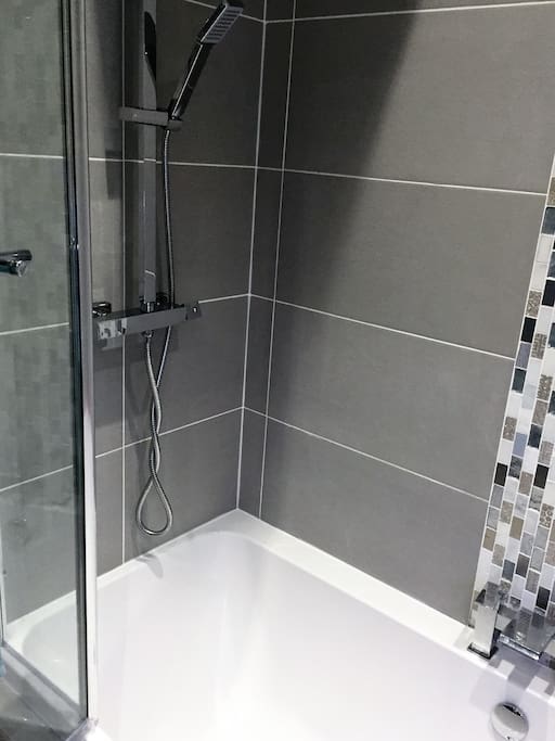 Luxury bathroom with large shower over bath.