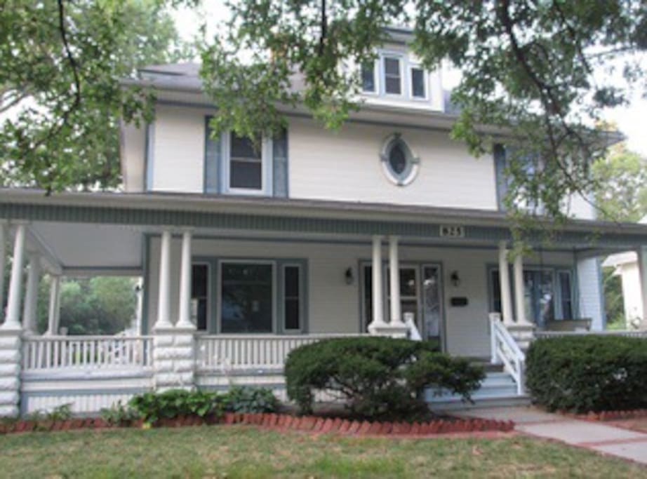 Wrap around porch with seating and swing pictured in summer
