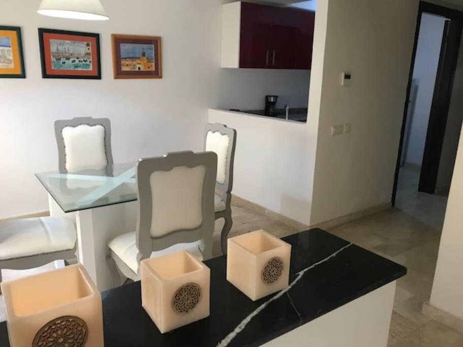 Salle à manger pour 4 personnes, très lumineuse, donnant sur la cuisine semi ouverte.
