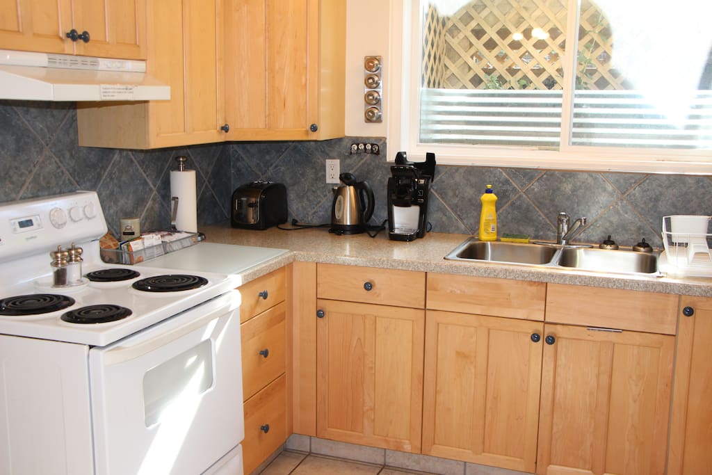 Another view of kitchen with Keurig machine, toaster, kettle & some coffee/tea/oatmeal.