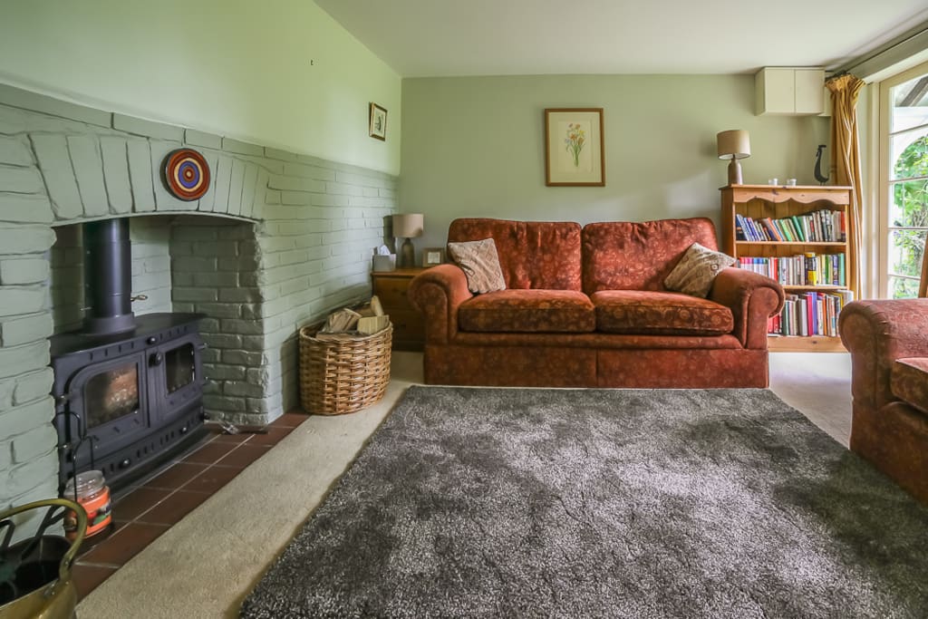 Cosy sitting room with wood burner