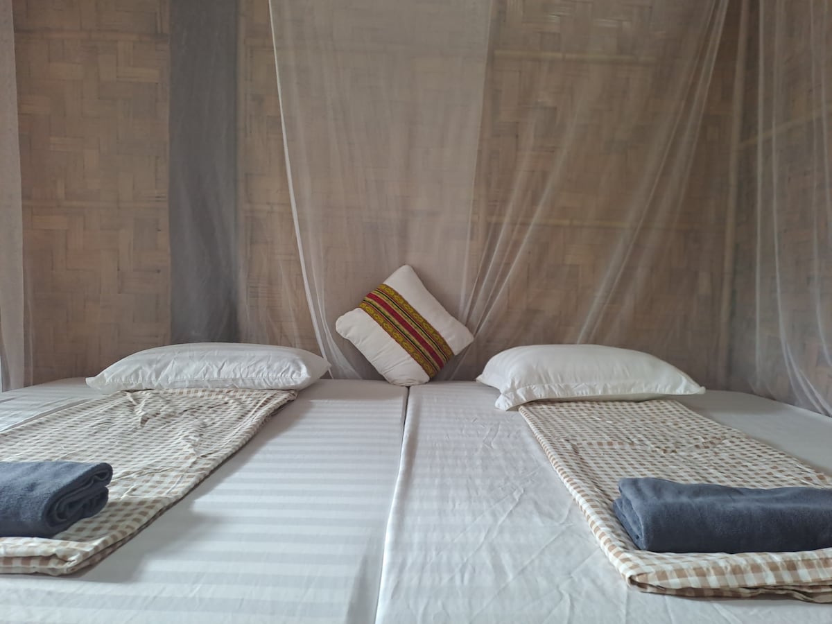 A double room is a simple, small bedroom with 2 single mattresses or 1 double mattress. The room has clean blankets, sheets, pillows, mattresses, fans and mosquito nets. A small balcony with tables and chairs.